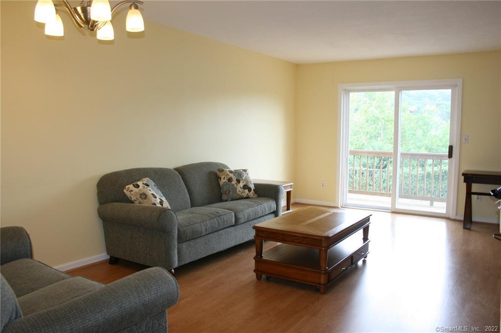 92 Commodore Cmns, Unit 92 Derby, CT 06418 - Photo 6 of 21 a living room with furniture and a large window