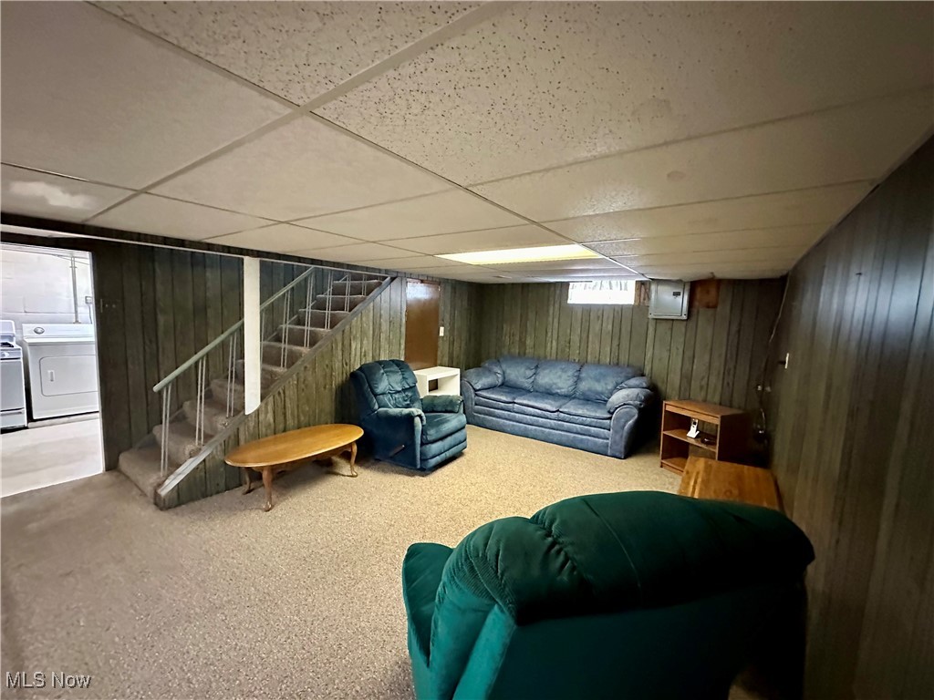 343 Raleigh Avenue Weirton, WV 26062 - Photo 24 of 46 Basement with washing machine and clothes dryer, a paneled ceiling, carpet, and wooden walls