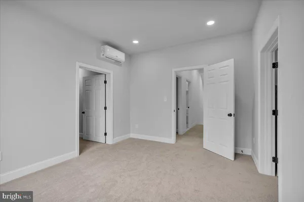 a bathroom with a toilet sink vanity and mirror