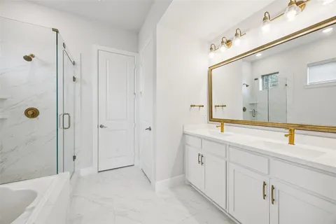 a bathroom with a double vanity sink and mirror