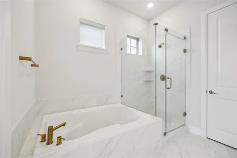 a bathroom with a tub and a shower