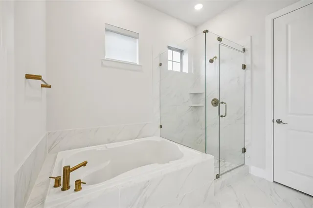 a bathroom with a tub and a shower