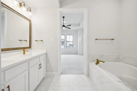 a bathroom with a bathtub sink and mirror