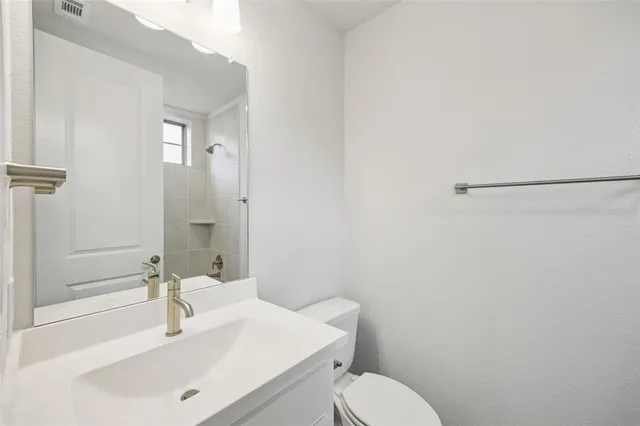 a bathroom with a sink toilet and vanity