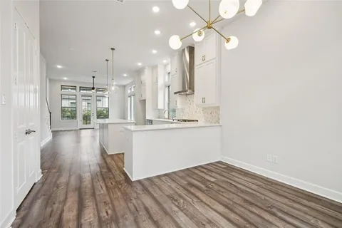 a view of a kitchen with wooden floor and a kitchen view