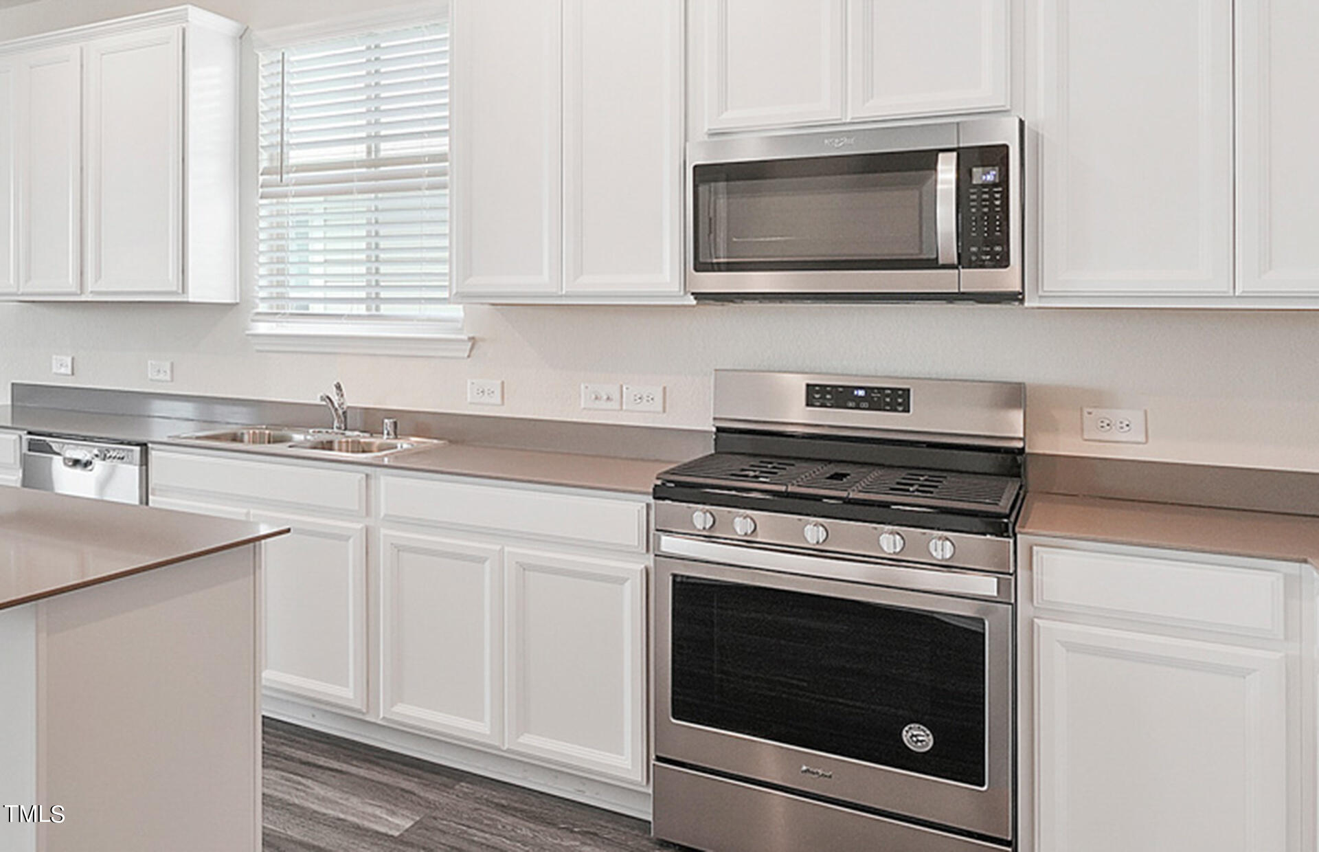 537 Campbell Rdg Place Wendell, NC 27591 - Photo 4 of 16 a kitchen with stainless steel appliances granite countertop white cabinets and a stove top oven