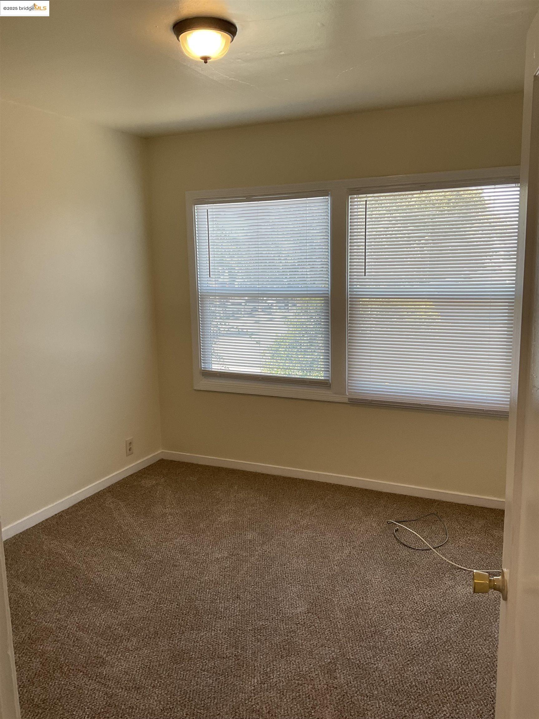 508 McLaughlin Street Richmond, CA 94805 - Photo 4 of 6 a view of an empty room with a window