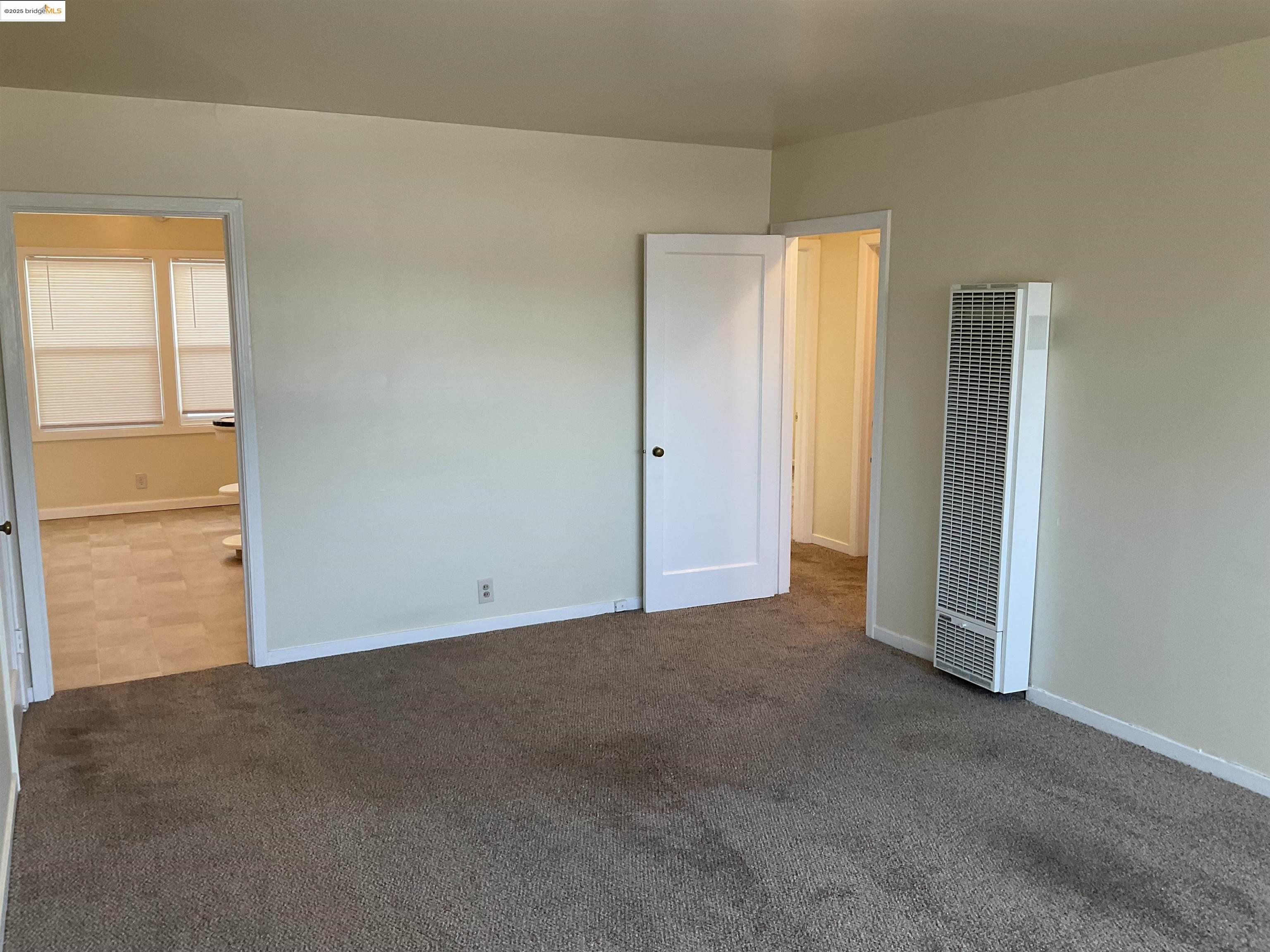 508 McLaughlin Street Richmond, CA 94805 - Photo 6 of 6 an empty room with windows and closet