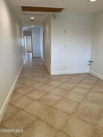 a bathroom with a granite countertop toilet sink and mirror