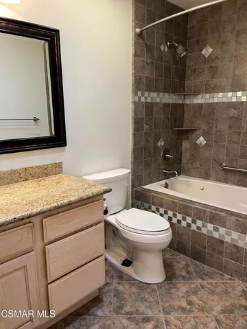 a bathroom with a glass door shower and a sink
