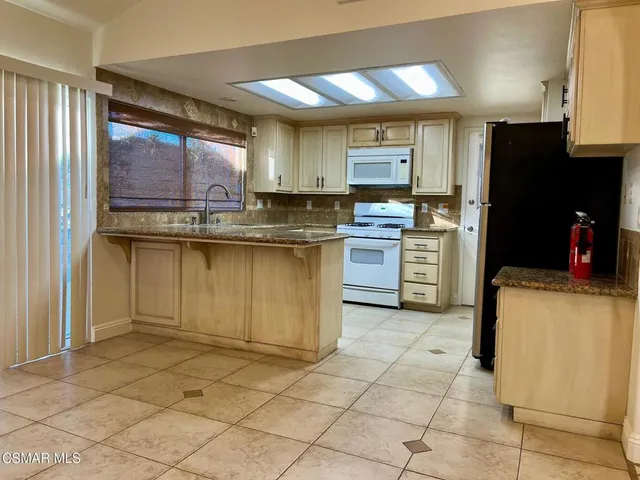 a kitchen with a sink cabinets and window