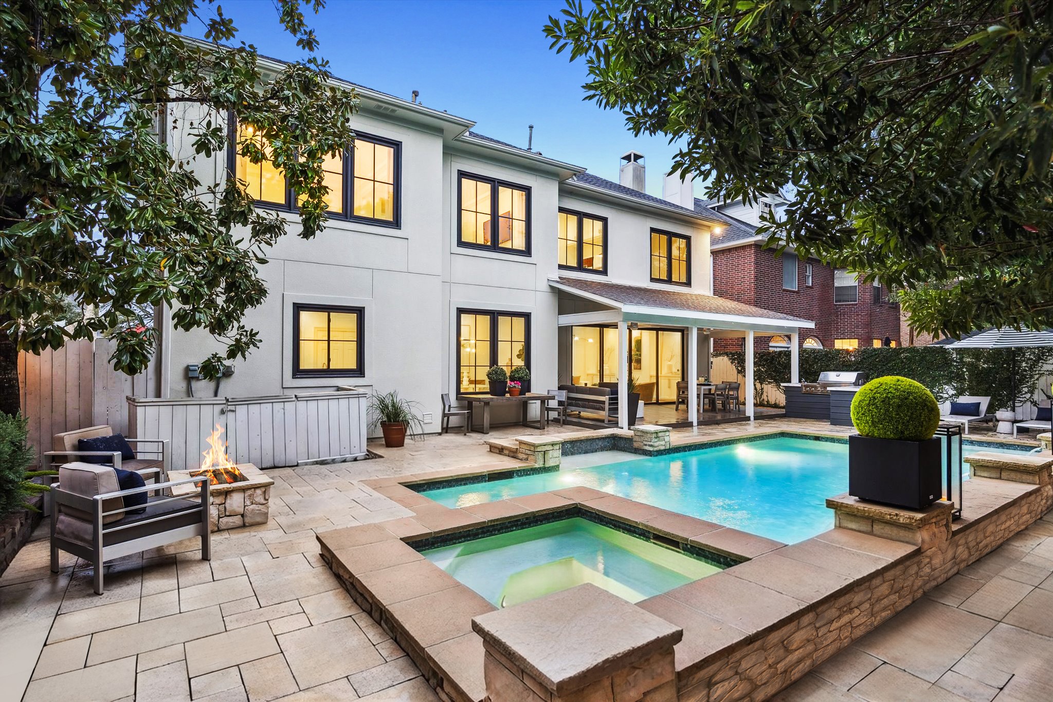 4122 Rice Boulevard West University Place, TX 77005 - Photo 24 of 30 Thoughtfully designed with both recreation and relaxation in mind, the pool and spa provide endless enjoyment while the fireside seating area offers a cozy gathering space for conversation after sunset.