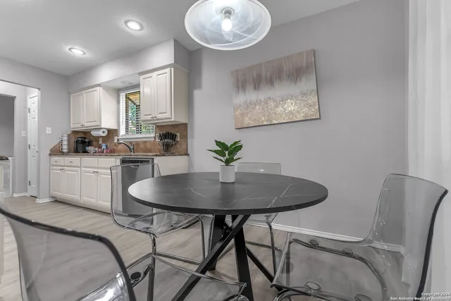 a view of a dining room with furniture and a chandelier