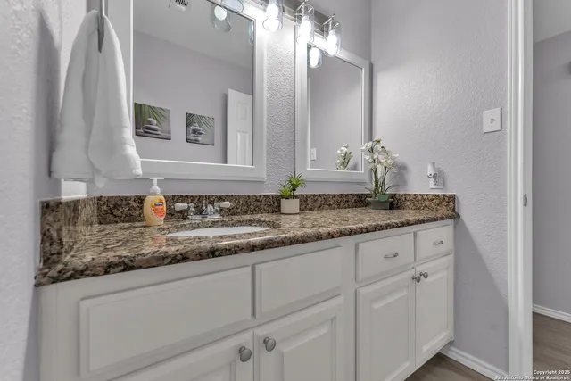 a bathroom with double sink and a mirror
