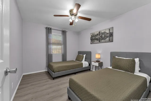 a bedroom with two beds and a chandelier