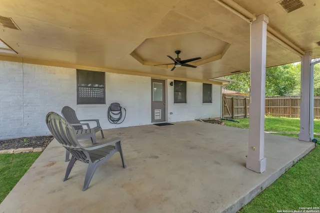 a view of a porch with furniture and a yard