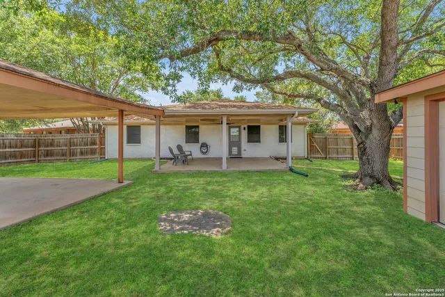 a view of a house with a backyard porch and sitting area