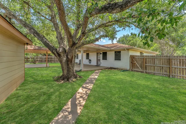 a front view of a house with yard and green space
