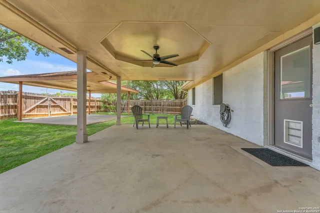 a view of a porch with furniture and garden