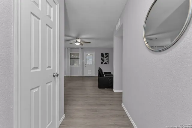 a view of a livingroom with wooden floor and staircase