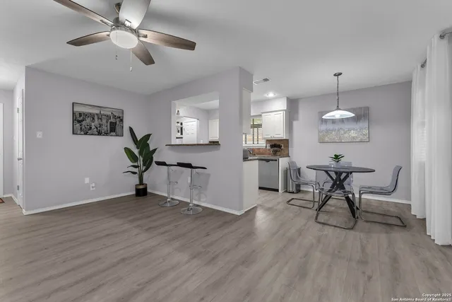 a view of a livingroom with furniture and a table wooden floor