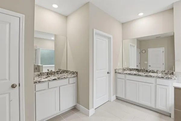 a bathroom with a granite countertop sink a mirror and a shower