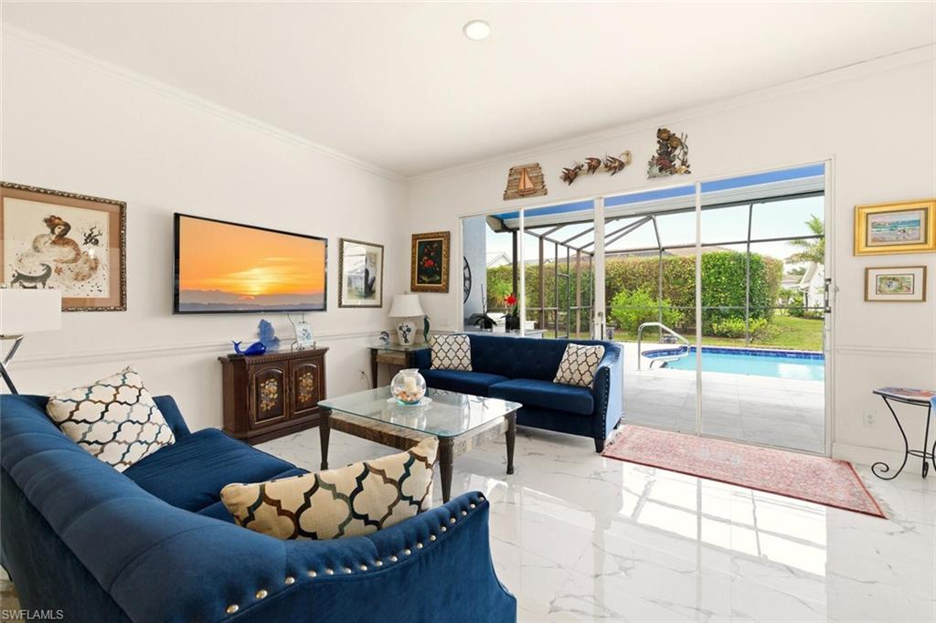 209 Countryside Drive Naples, FL 34104 - Photo 15 of 50 Living area featuring a sunroom, ornamental molding, marble tiled floors, and recessed lighting