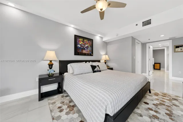 a bedroom with a large bed and a large window