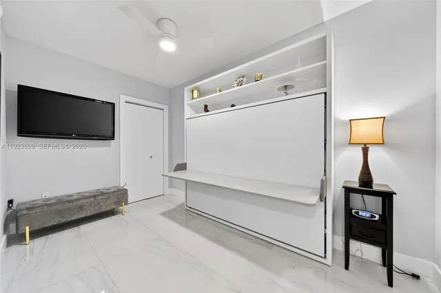 a bathroom with a sink a toilet a mirror and shower