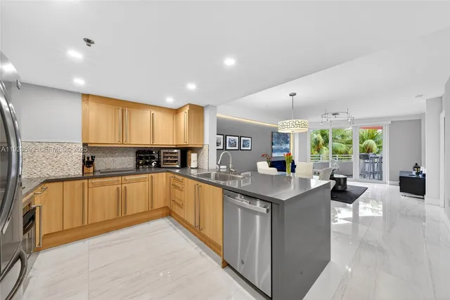 a kitchen with kitchen island granite countertop a stove and a sink