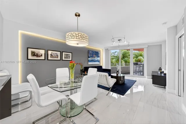 a living room with furniture a window and a chandelier