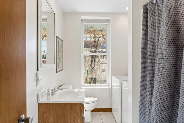 a view of a hallway with wooden floor and entryway