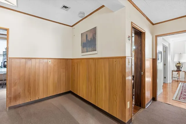 a work room with furniture and large windows