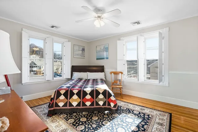 a bedroom with a bed and wooden floor