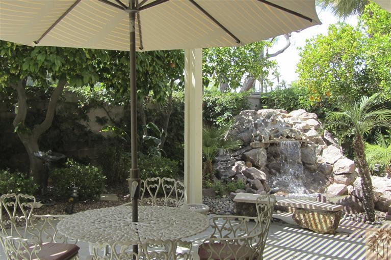 78591 Dancing Waters Road Palm Desert, CA 92211 - Photo 1 of 17 a view of a chairs and table in the patio