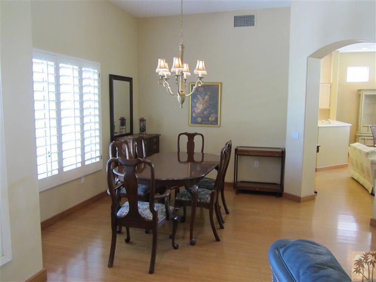 78591 Dancing Waters Road Palm Desert, CA 92211 - Photo 11 of 17 a view of a dining room with furniture and wooden floor