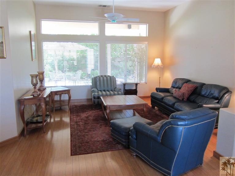 78591 Dancing Waters Road Palm Desert, CA 92211 - Photo 12 of 17 a living room with furniture and a large window