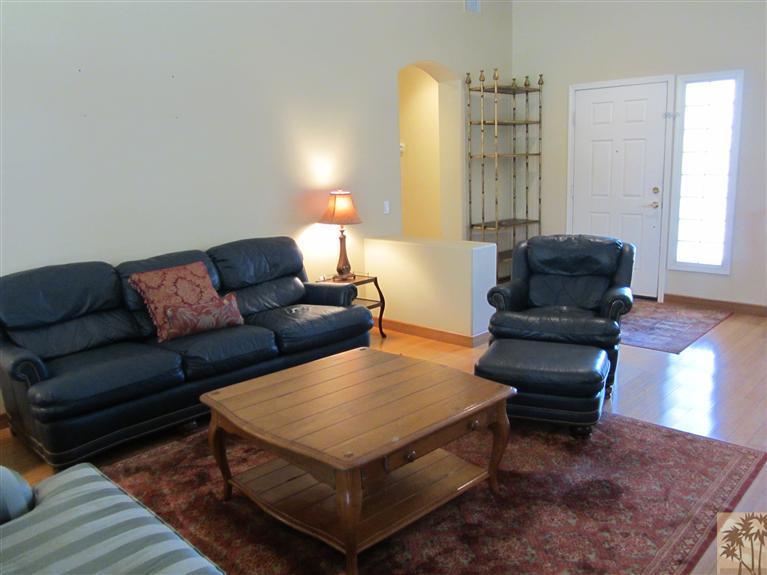 78591 Dancing Waters Road Palm Desert, CA 92211 - Photo 13 of 17 a living room with furniture and a lamp