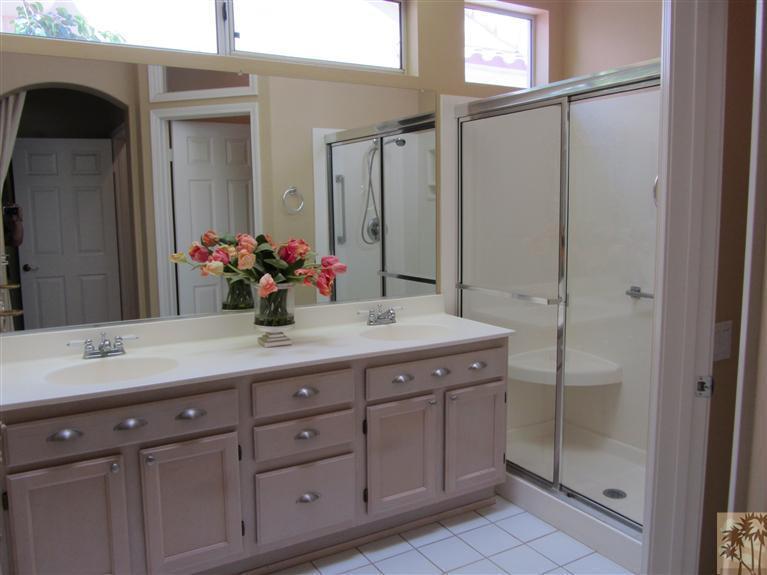 78591 Dancing Waters Road Palm Desert, CA 92211 - Photo 14 of 17 a bathroom with a sink vanity and a mirror