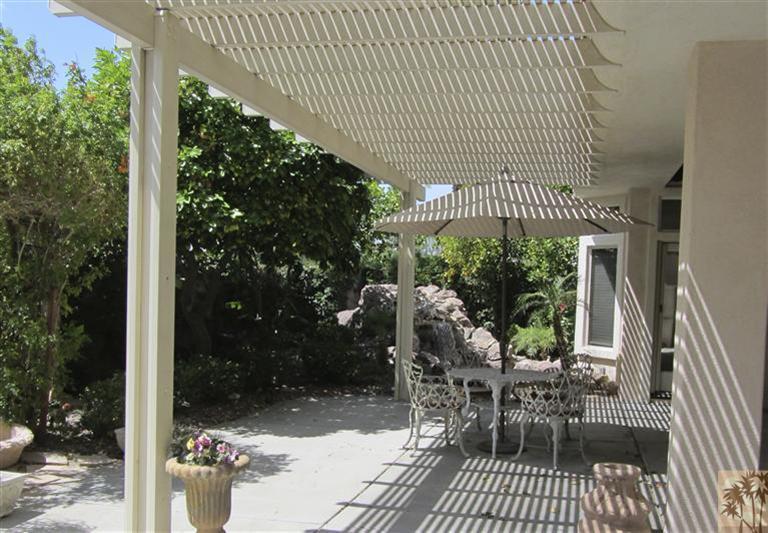 78591 Dancing Waters Road Palm Desert, CA 92211 - Photo 16 of 17 a view of a patio with dining table and chairs