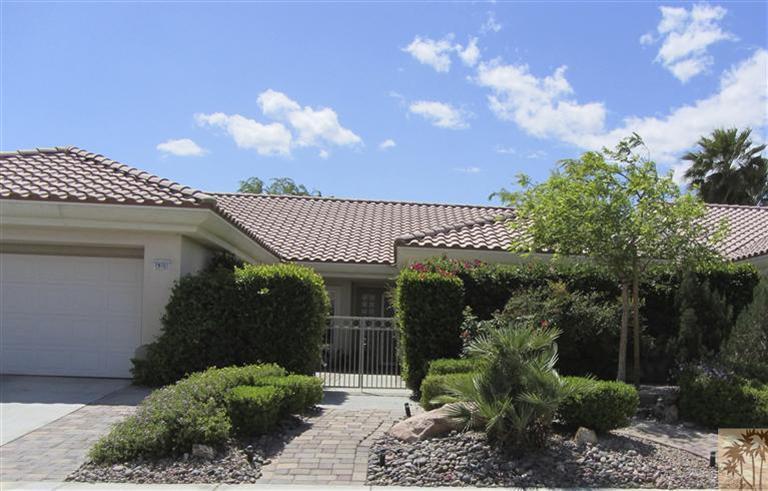 78591 Dancing Waters Road Palm Desert, CA 92211 - Photo 2 of 17 a view of a house with a small yard and a garden