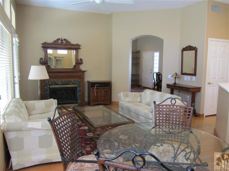 78591 Dancing Waters Road Palm Desert, CA 92211 - Photo 9 of 17 a living room with furniture and a fireplace