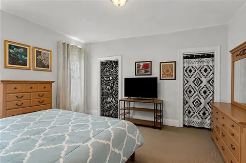 a bedroom with a bed and a television