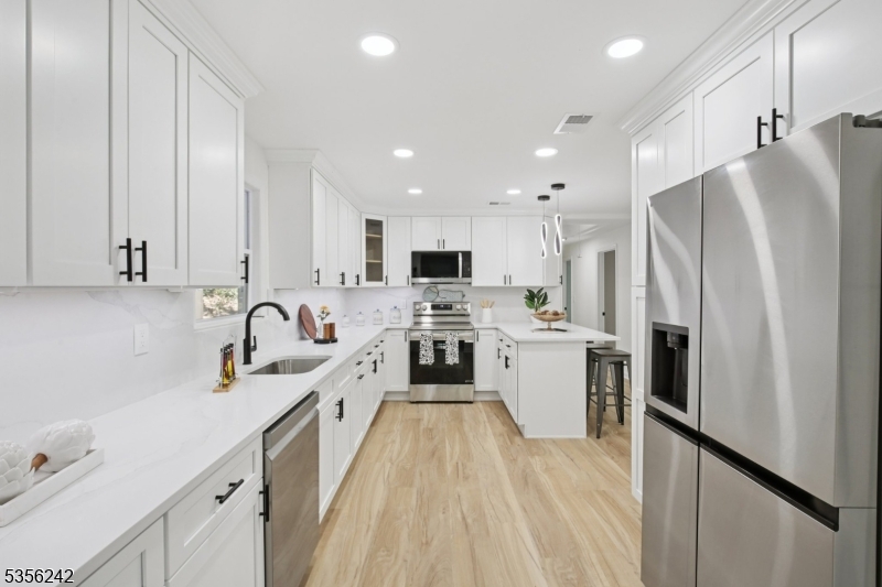 16 Wildcat Road Sparta, NJ 07871 - Photo 12 of 38 a kitchen with stainless steel appliances a refrigerator sink and white cabinets