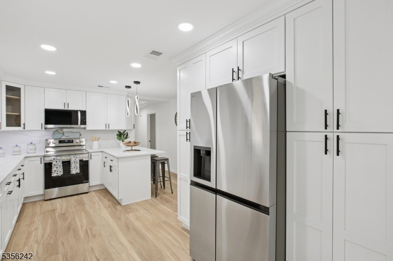16 Wildcat Road Sparta, NJ 07871 - Photo 17 of 38 a kitchen with stainless steel appliances a refrigerator sink and microwave