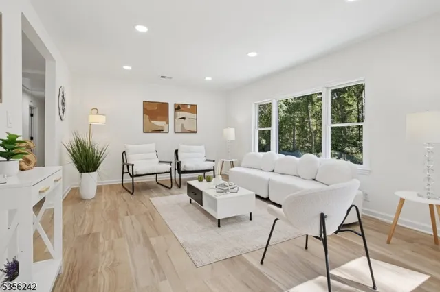 a living room with furniture and large windows