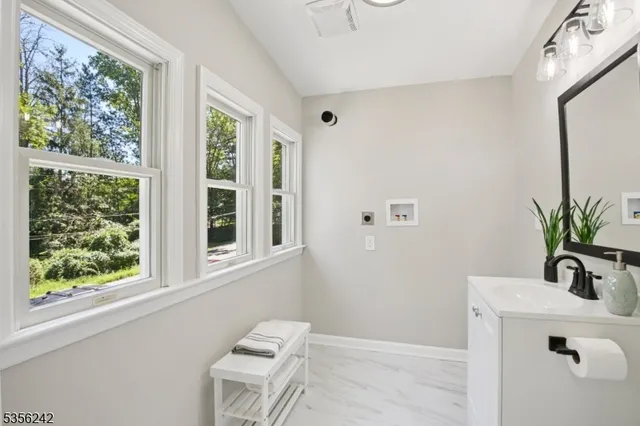 a bathroom with a sink a mirror and a window