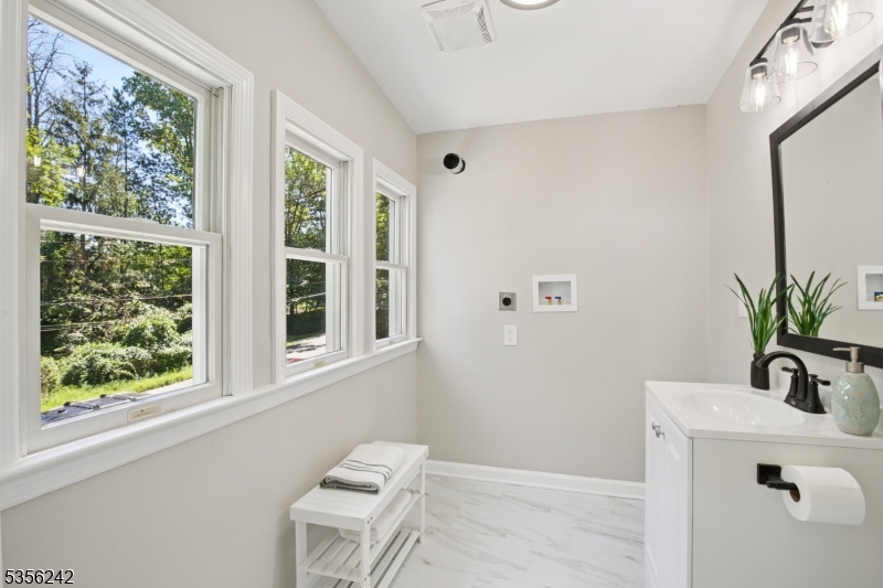16 Wildcat Road Sparta, NJ 07871 - Photo 27 of 38 a bathroom with a sink a mirror and a window
