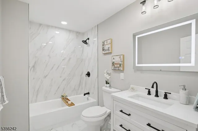 a bathroom with a sink a toilet and a tub