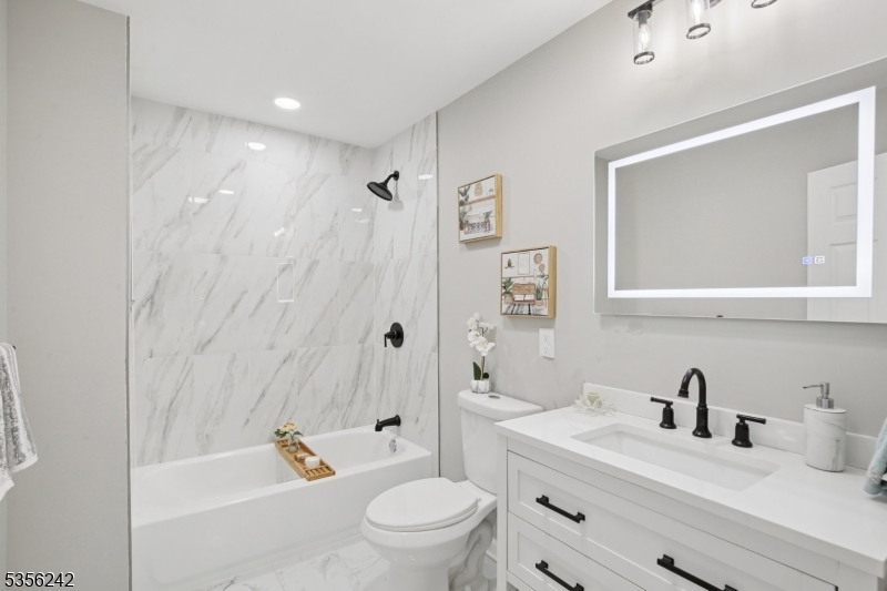 16 Wildcat Road Sparta, NJ 07871 - Photo 32 of 38 a bathroom with a sink a toilet and a tub